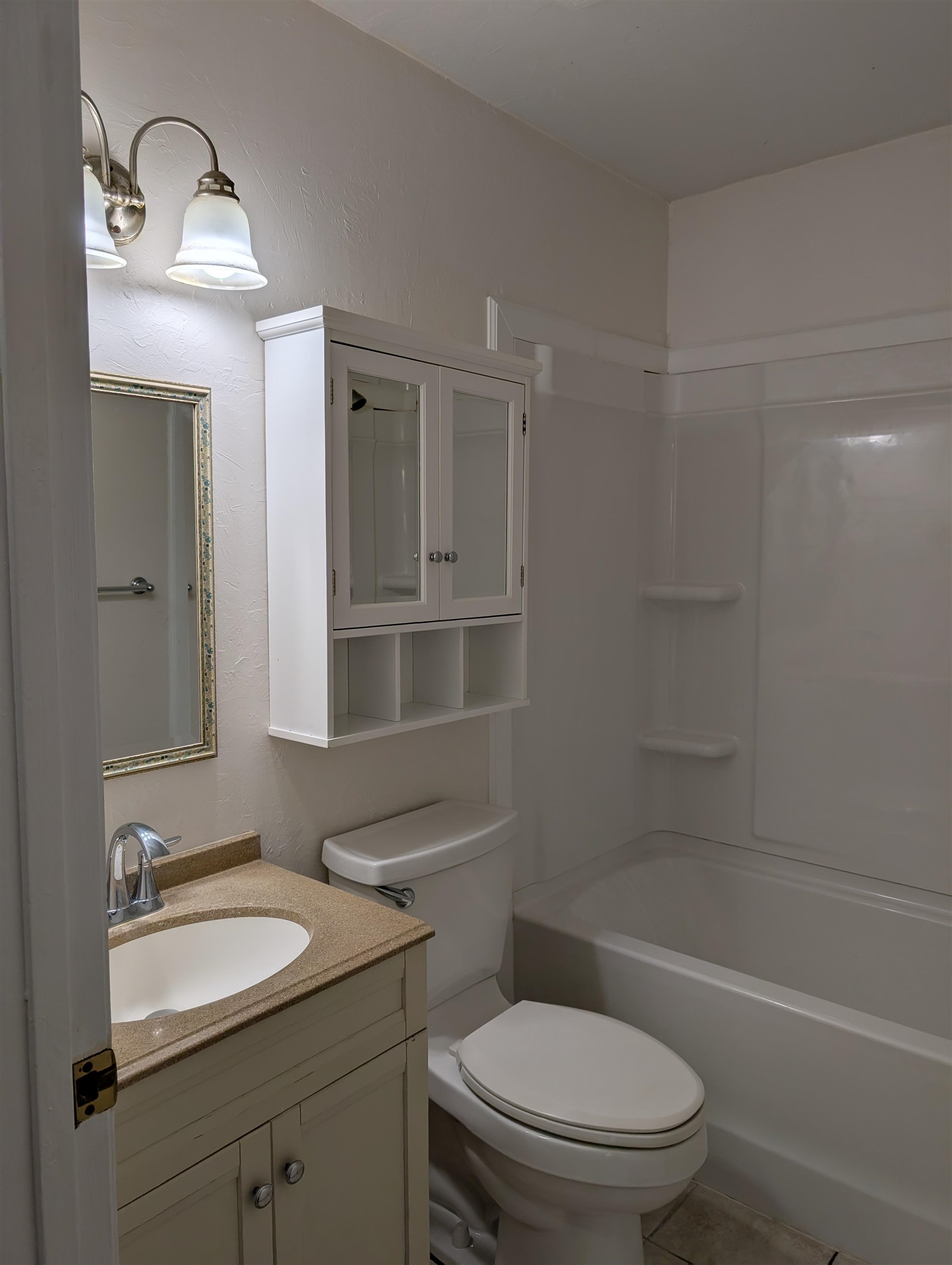 3891 Osprey Circle, Unit B St. Augustine, FL 32086 - Photo 14 of 18 a bathroom with a sink toilet vanity granite tub and shower