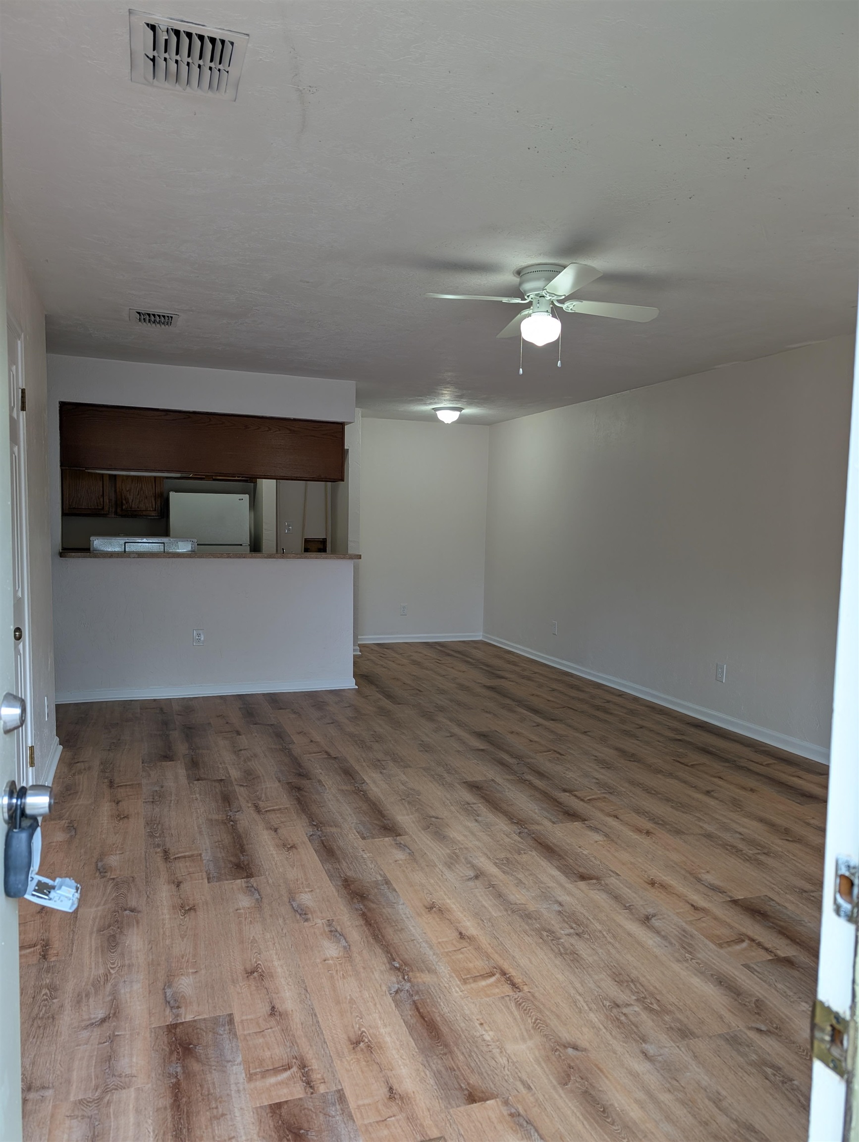 3891 Osprey Circle, Unit B St. Augustine, FL 32086 - Photo 2 of 18 a view of empty room with wooden floor and ceiling fan
