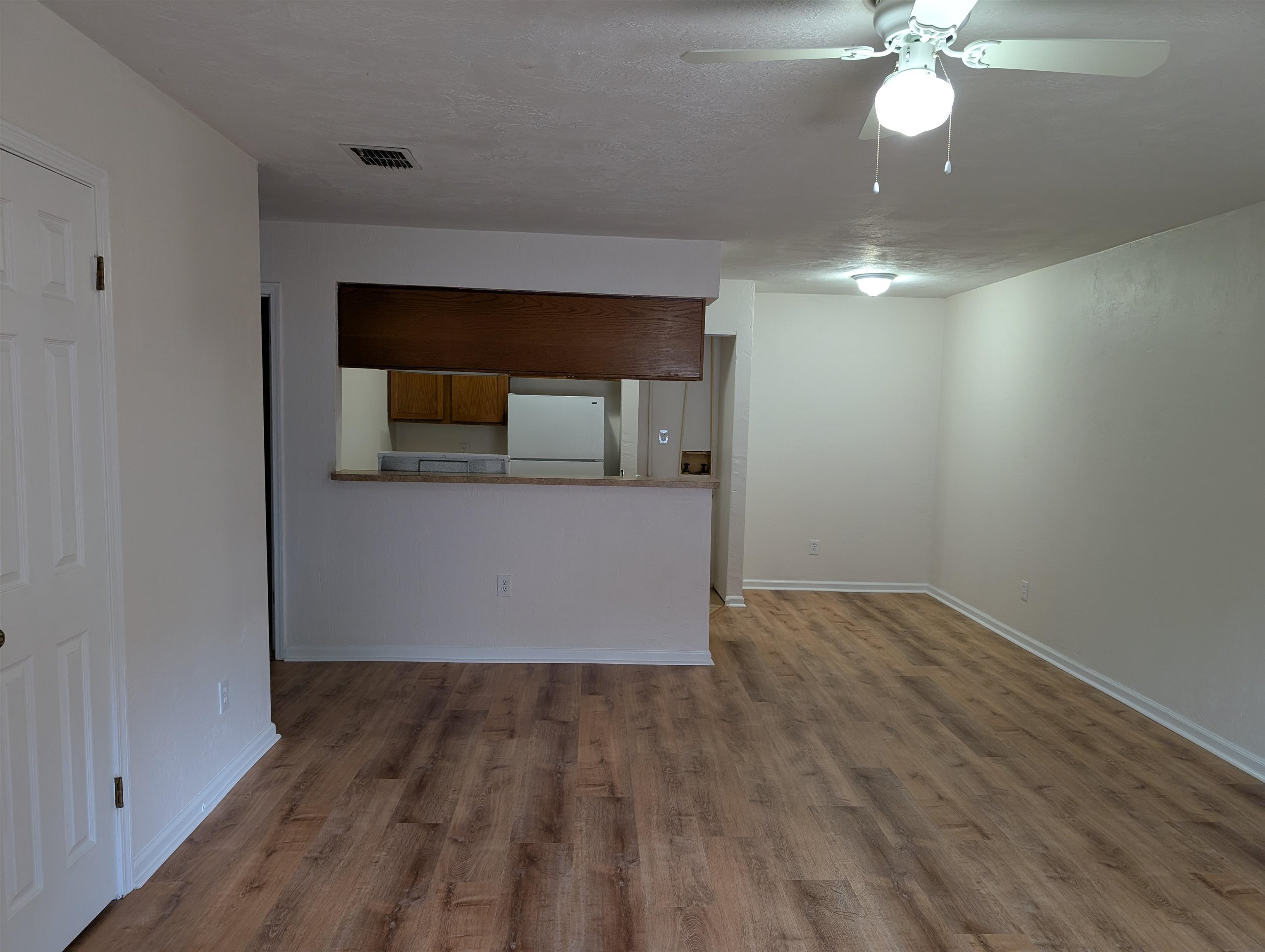 3891 Osprey Circle, Unit B St. Augustine, FL 32086 - Photo 3 of 18 an empty room with wooden floor fan and windows