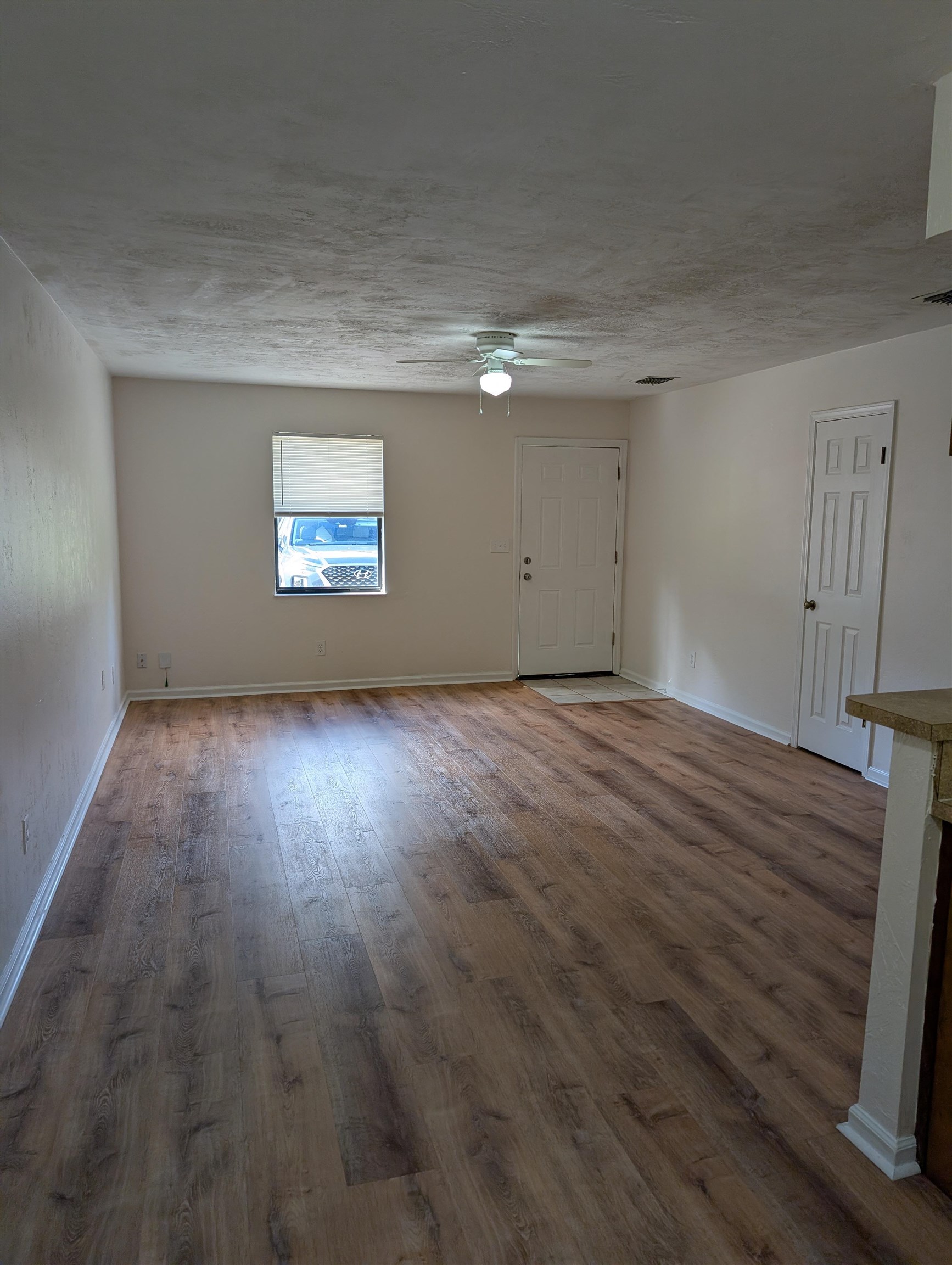 3891 Osprey Circle, Unit B St. Augustine, FL 32086 - Photo 4 of 18 a view of an empty room with wooden floor and a window