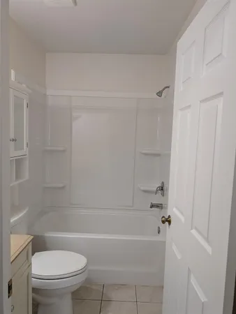 a bathroom with a toilet and a bathtub