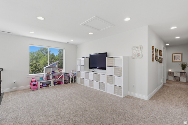 10676 Urban Rdg Cove South Jordan, UT 84095 - Photo 35 of 48 Expansive carpeted area featuring recessed lighting, a large window, white walls, and white baseboards