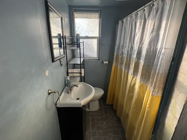 a bathroom with a sink a mirror and a shower