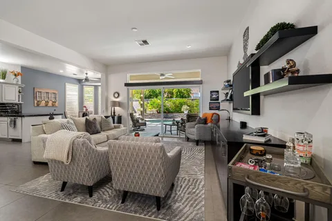 a living room with furniture fireplace and a window