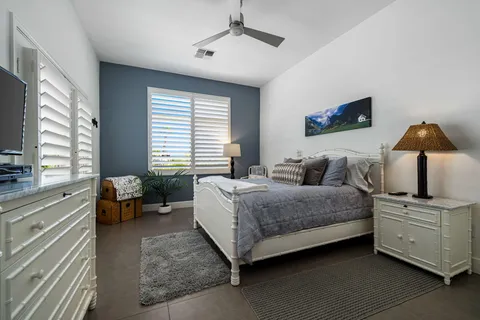 a bedroom with a large bed and a chandelier