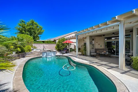 a view of a swimming pool with sitting area