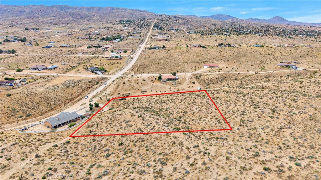 24575 Ocotillo Way Apple Valley, CA 92308 - Photo 10 of 13 a view of a dry yard with wooden floor and a mountain view