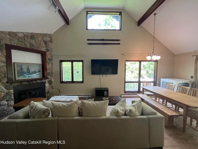 a living room with furniture rug and wooden floor
