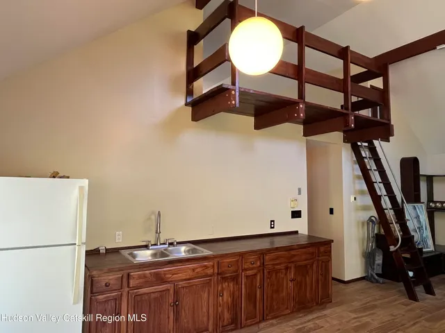 a room with gym equipment and wooden floor