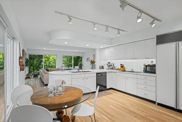 a kitchen with a table chairs stove and cabinets