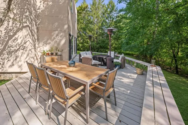 a view of backyard with table and chairs and wooden floor