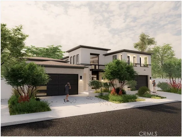 a front view of a house with a yard garage and outdoor seating
