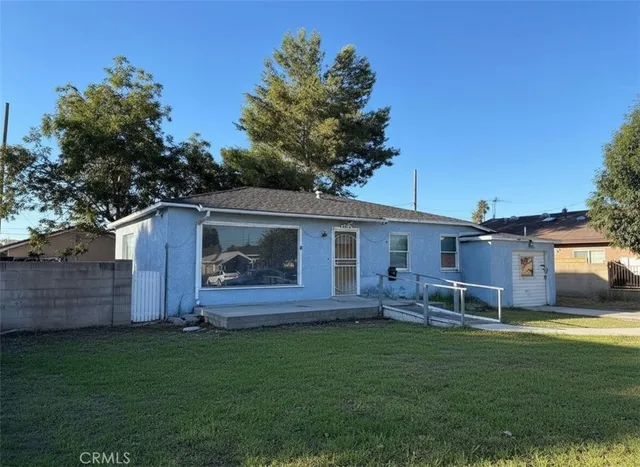 a view of house with backyard and garden