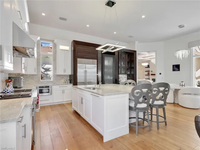a large kitchen with cabinets a sink and a stove