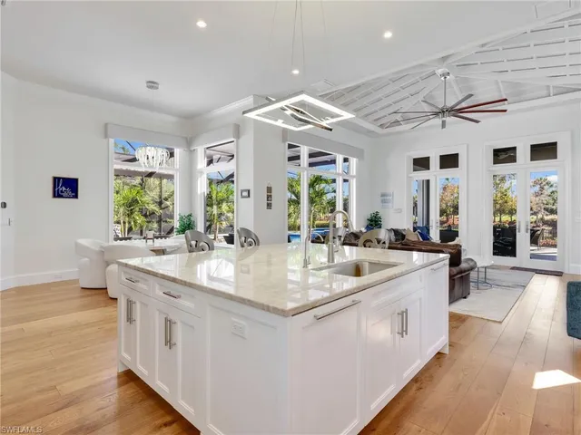 a large white kitchen with a large window