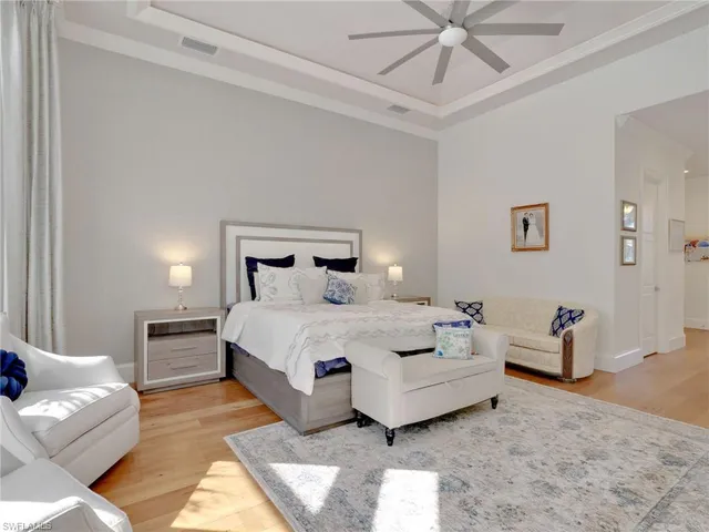 a bedroom with a bed and ceiling fan