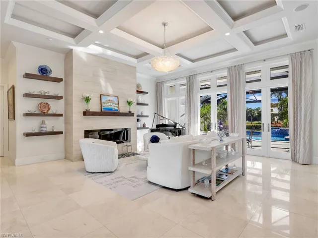 a living room with furniture a window and kitchen view