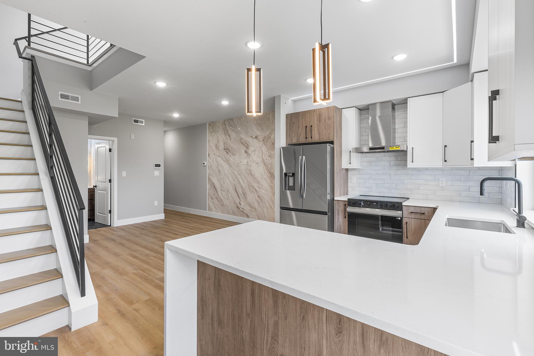 1413 North 8th Street Philadelphia, PA 19122 - Photo 1 of 44 a kitchen with stainless steel appliances kitchen island granite countertop a sink a refrigerator and a stove