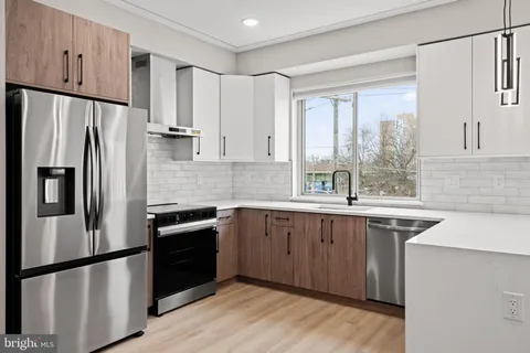 a kitchen with a refrigerator sink and cabinets