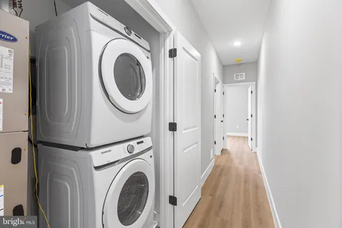 a view of a hallway with washer and dryer