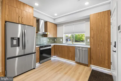 a kitchen with a refrigerator a sink and cabinets