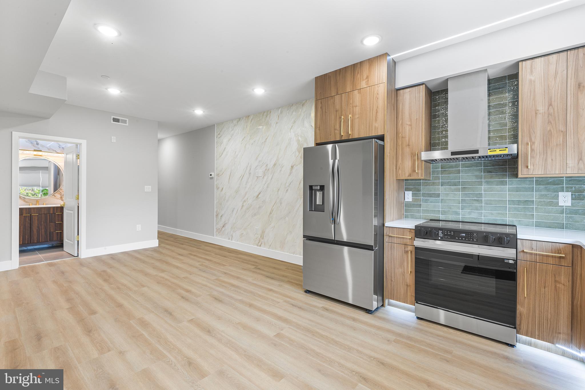 1413 North 8th Street Philadelphia, PA 19122 - Photo 14 of 44 a kitchen with stainless steel appliances granite countertop a refrigerator and a stove top oven