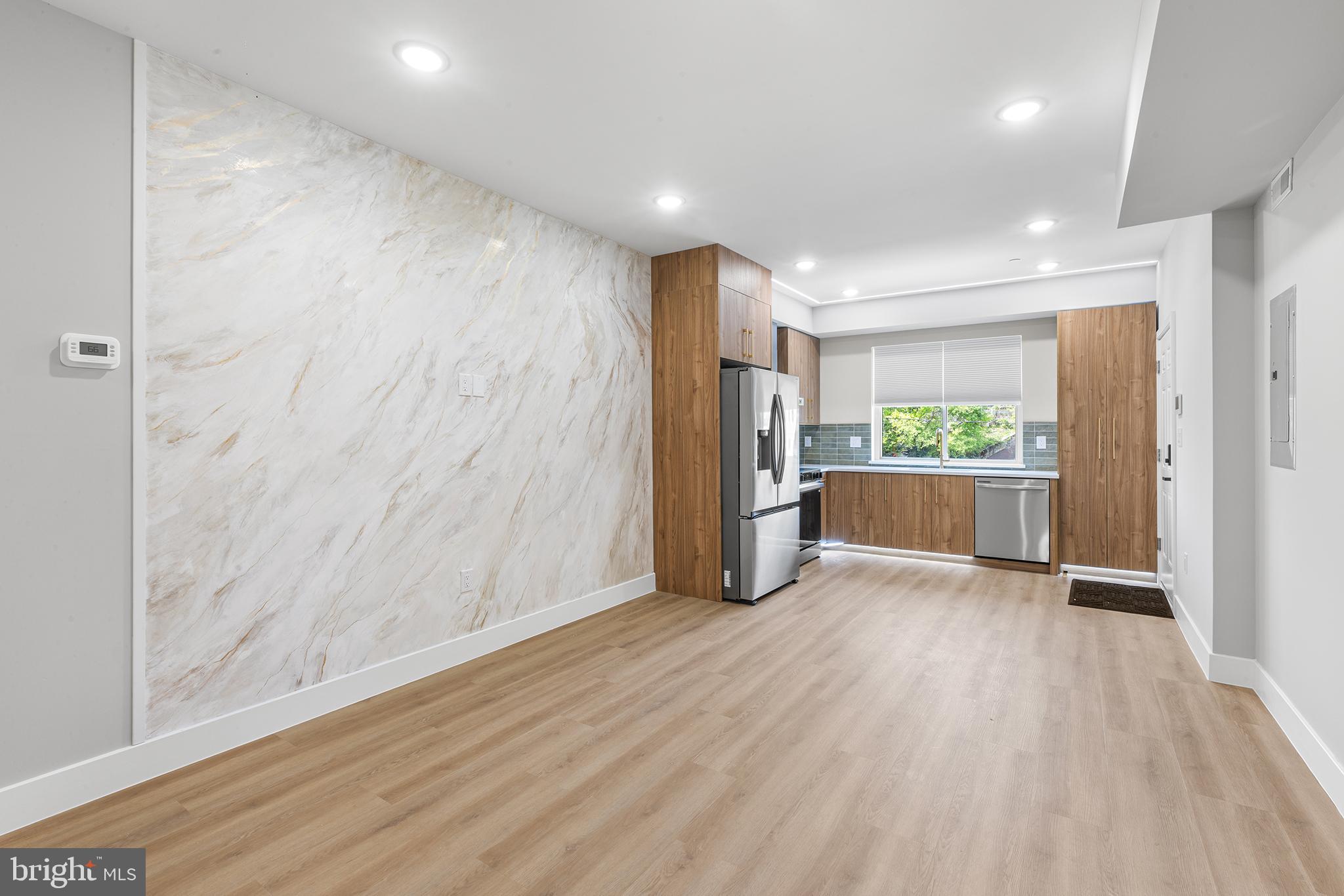1413 North 8th Street Philadelphia, PA 19122 - Photo 15 of 44 a view of a hallway with wooden floor and a kitchen