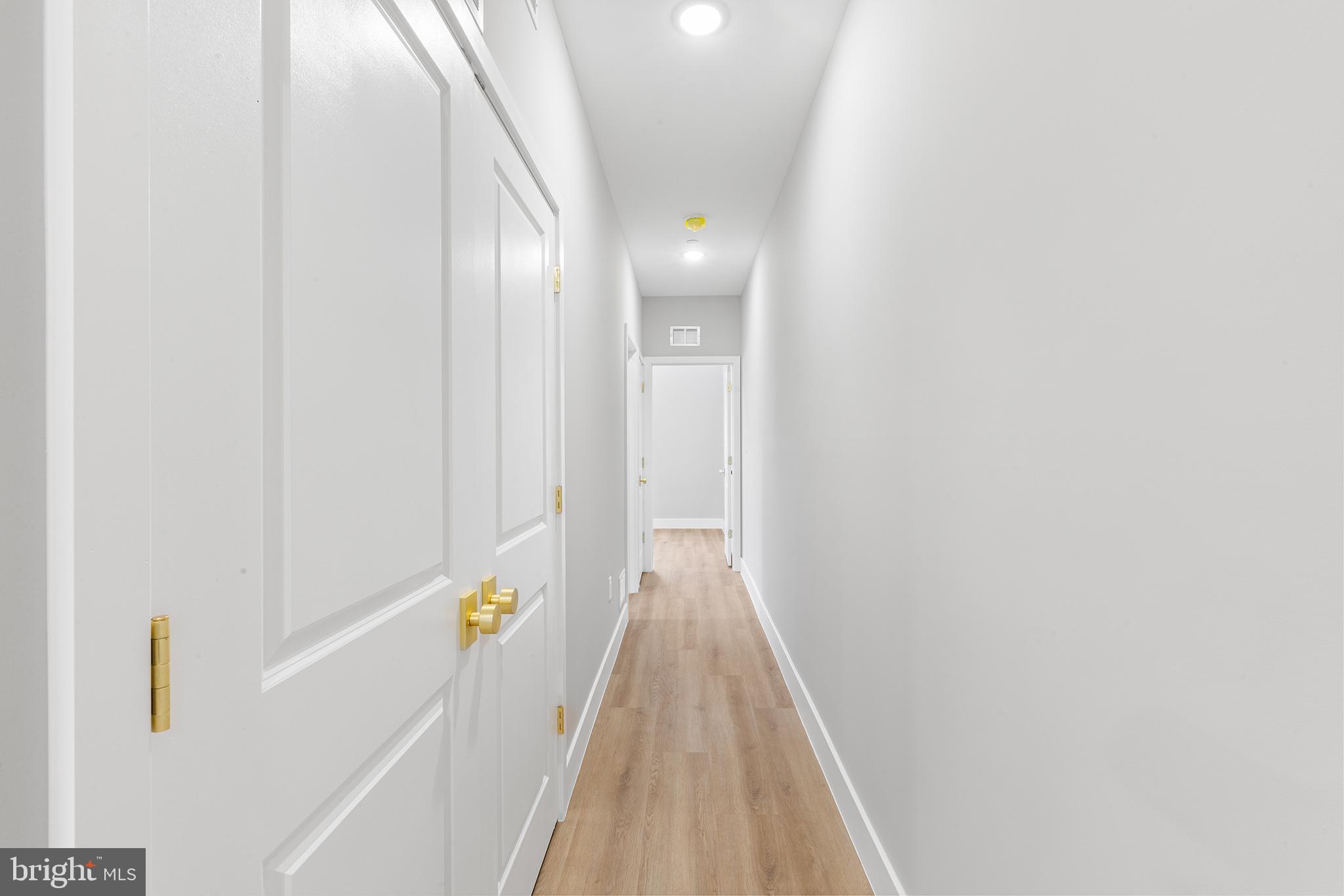 1413 North 8th Street Philadelphia, PA 19122 - Photo 16 of 44 a view of a hallway with wooden floor and stairs