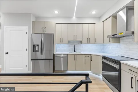 a kitchen with a refrigerator sink and cabinets