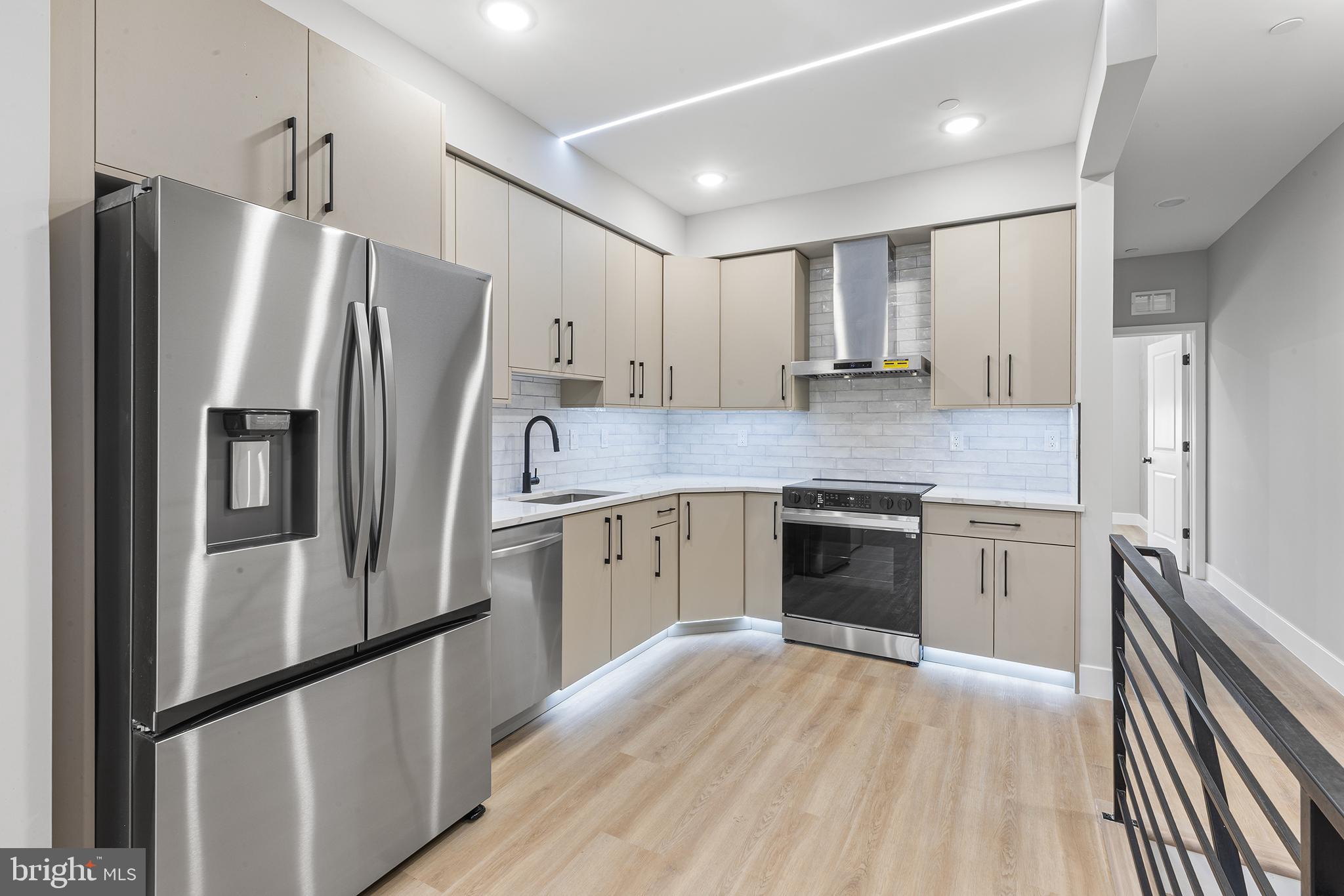 1413 North 8th Street Philadelphia, PA 19122 - Photo 27 of 44 a kitchen with granite countertop stainless steel appliances a refrigerator and cabinets