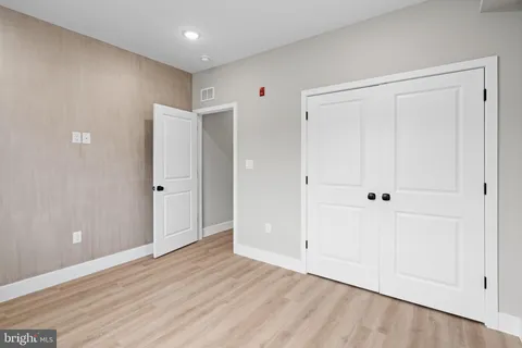 a view of a hallway with white walls and railing