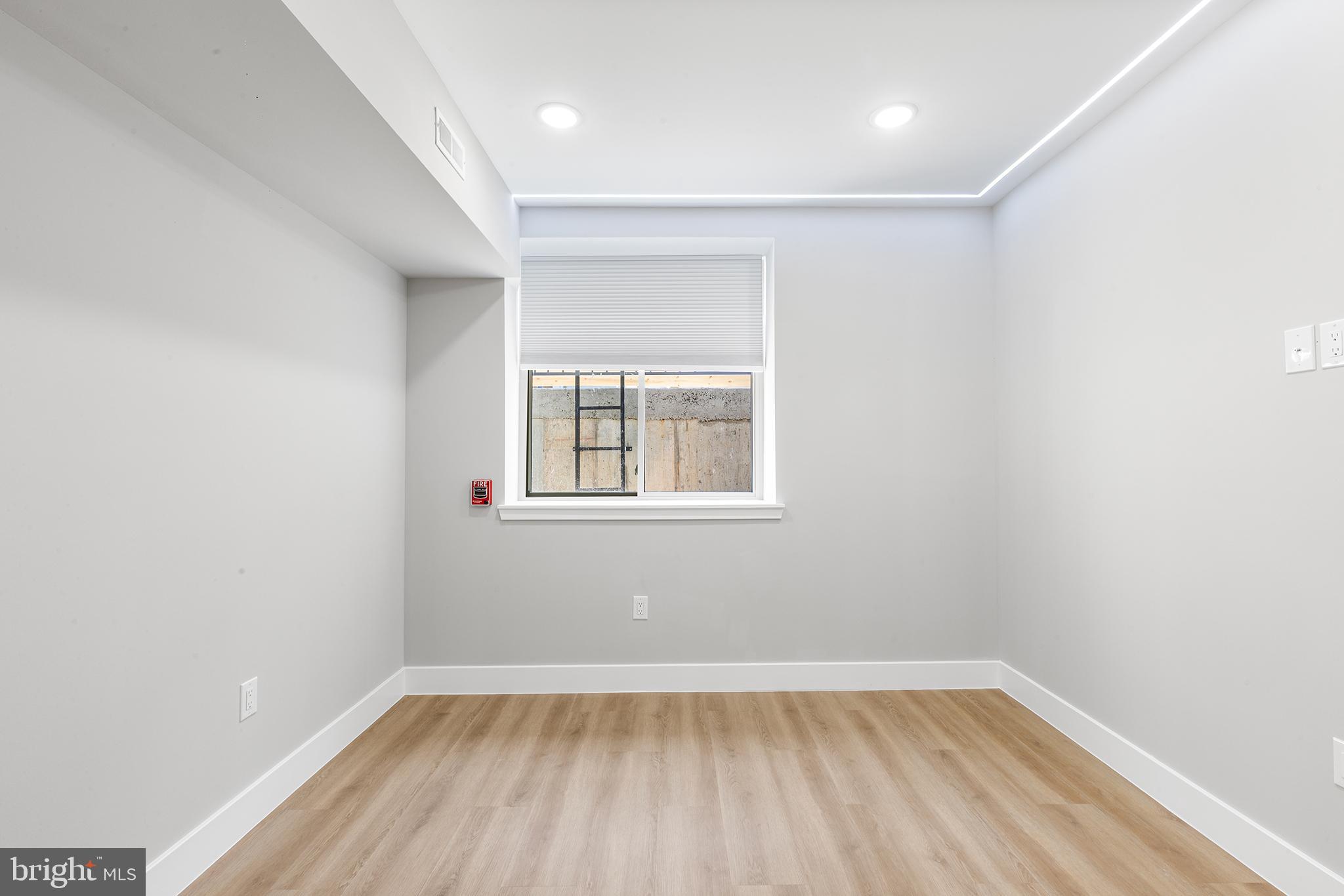 1413 North 8th Street Philadelphia, PA 19122 - Photo 35 of 44 wooden floor in an empty room with a window