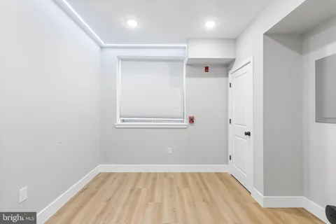 a view of a room with wooden floor and a hallway