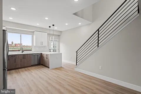a view of an entryway with wooden floor and stairs