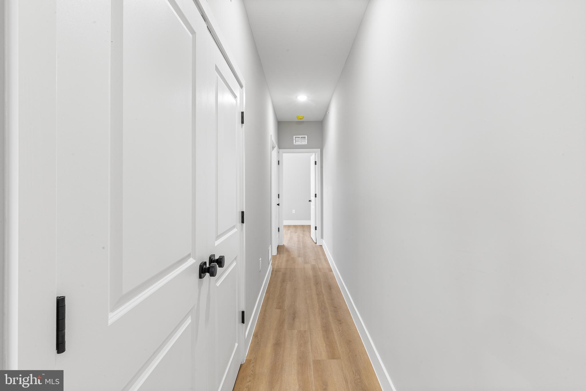 1413 North 8th Street Philadelphia, PA 19122 - Photo 6 of 44 a view of a hallway with wooden floor and staircase