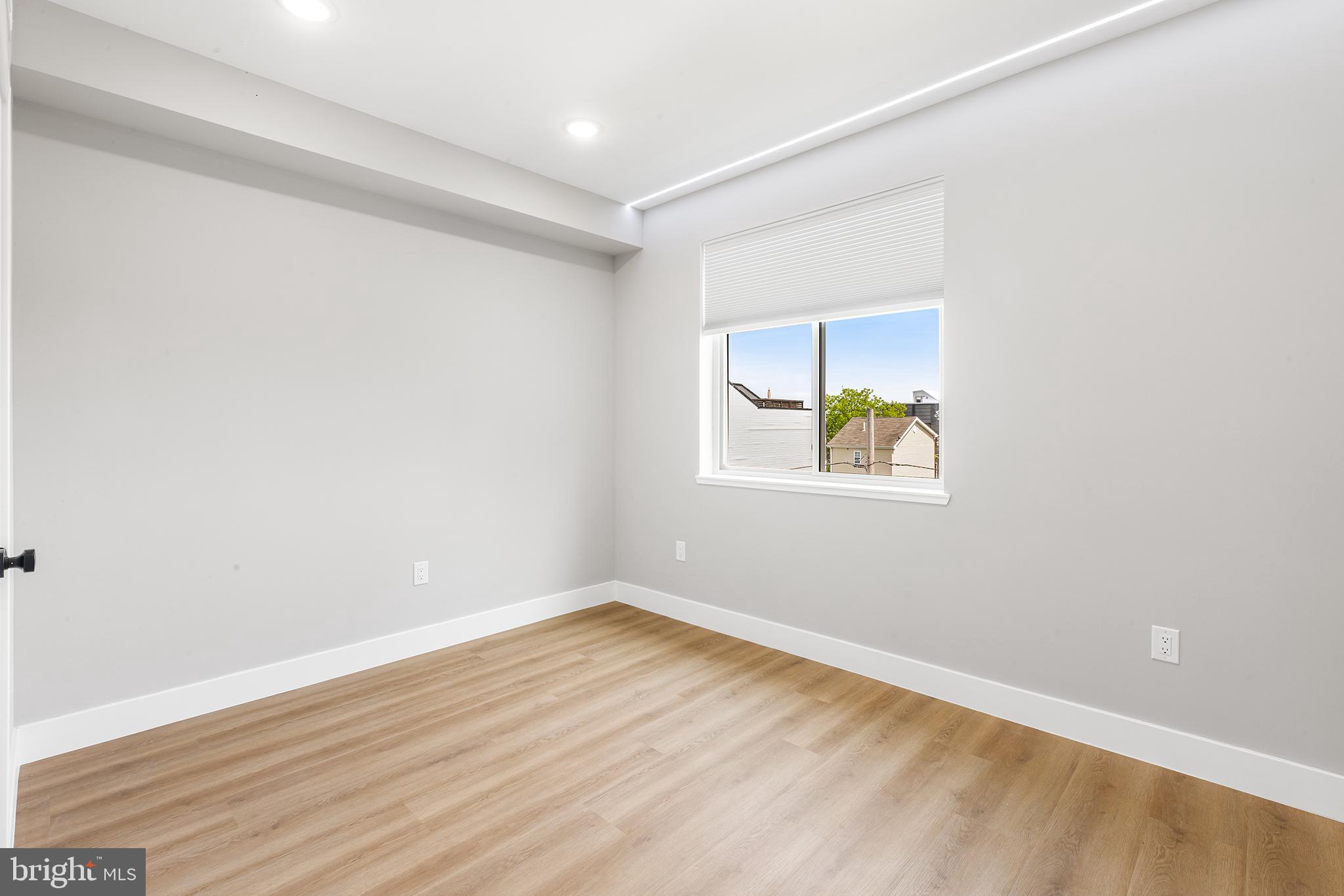 1413 North 8th Street Philadelphia, PA 19122 - Photo 7 of 44 an empty room with wooden floor and window