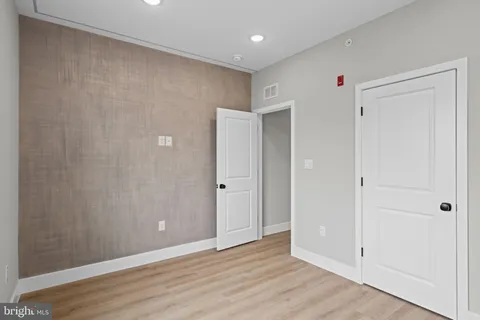 a bathroom with a toilet a sink a mirror a bathtub and vanity