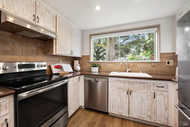 a kitchen with a stove and white cabinets