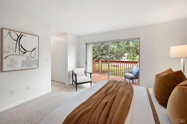 a bedroom with furniture and a large window