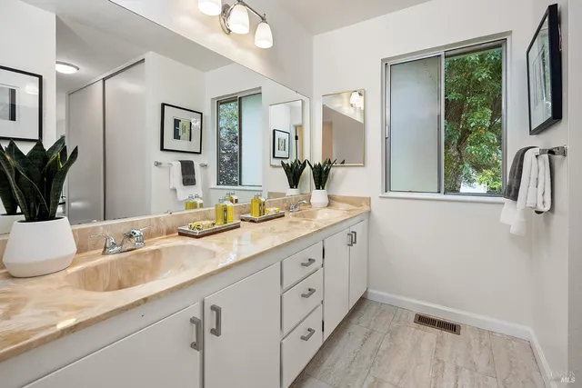 a bathroom with a granite countertop sink mirror and a
