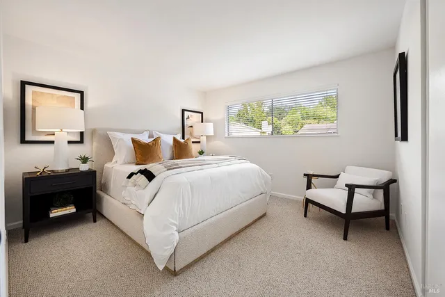 a bed room with a bed and a chair