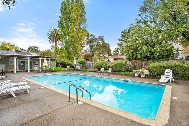 a view of a house with swimming pool and sitting area
