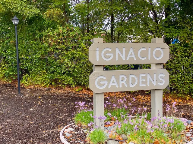 a street sign that is on a wooden wall
