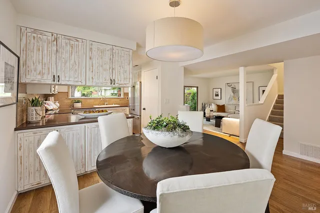 a kitchen with a dining table and chairs