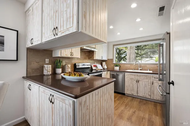 a kitchen with sink cabinets and window