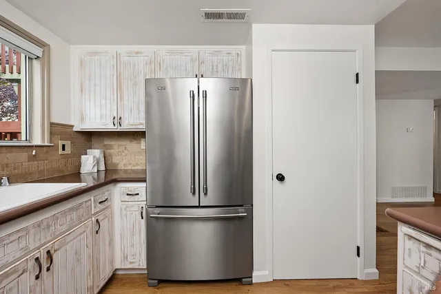 a white refrigerator freezer sitting in a kitchen