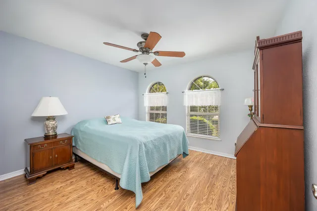 a bedroom with a bed a dresser and a window