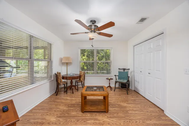 a living room with furniture and large windows