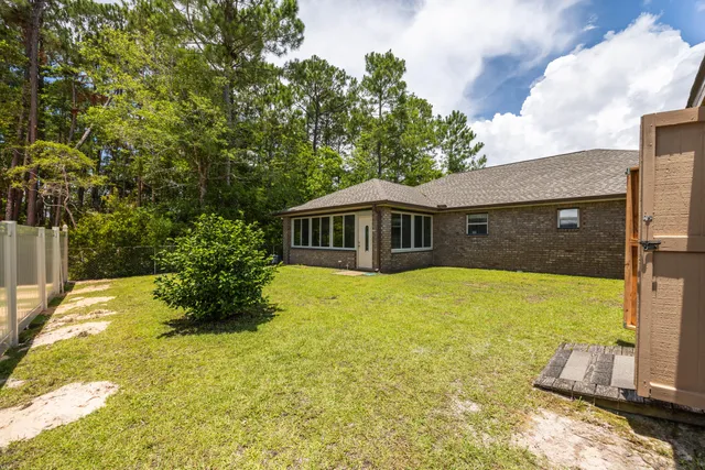 a yellow house with swimming pool in front of it