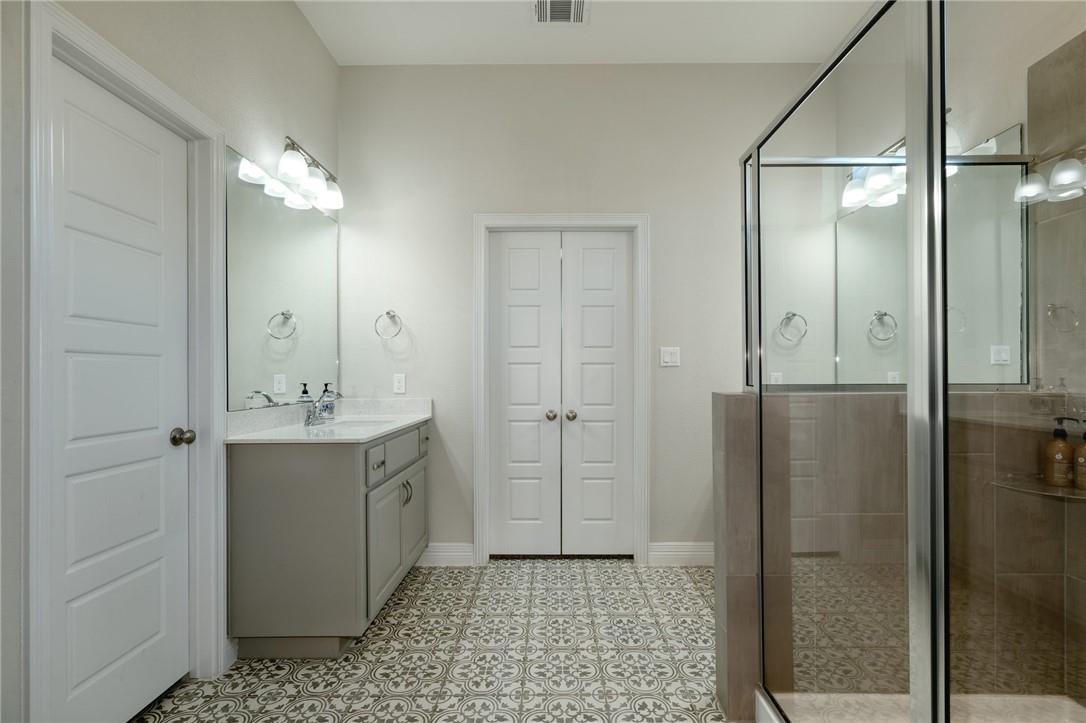 229 Bonnet Boulevard Georgetown, TX 78628 - Photo 11 of 20 a bathroom with a shower sink and mirror